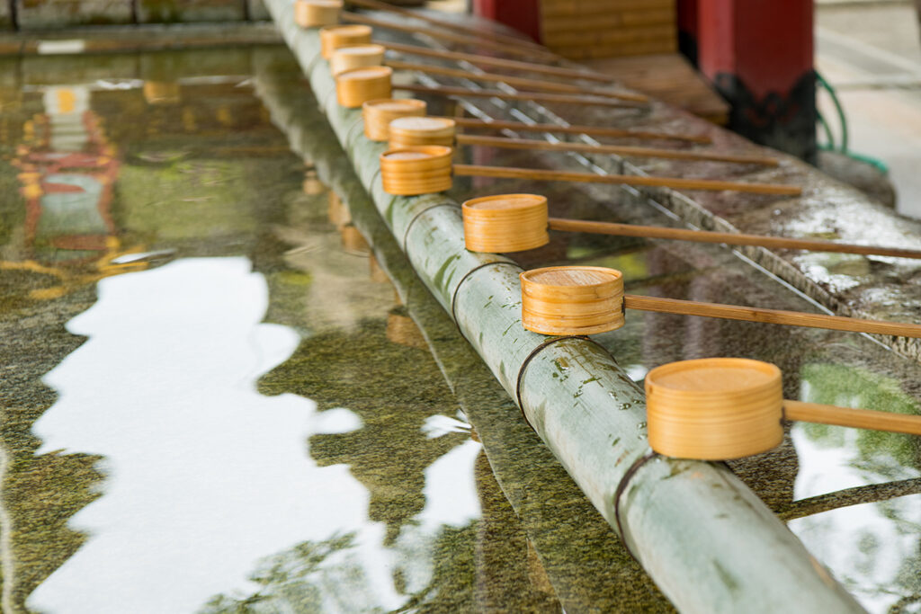 Water scoop at the approach to the shrine , Japanese water ablution pavilion, Dazaifu Tenmangu, Fukuoka, Kyushu, Japan.