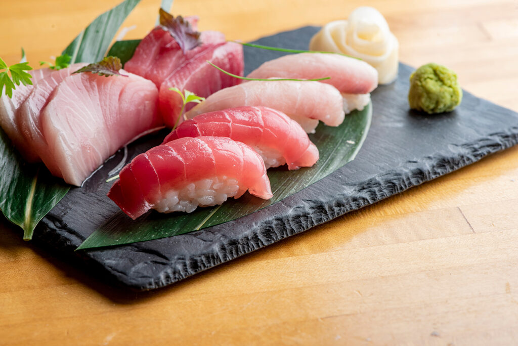 Sashimi sushi. Classic Traditional Japanese cuisine. Raw fish-salmon tuna, mackerel, fluke, bass--sliced very thin and served with a variety of garnishes pickled ginger and wasabi and sauces.