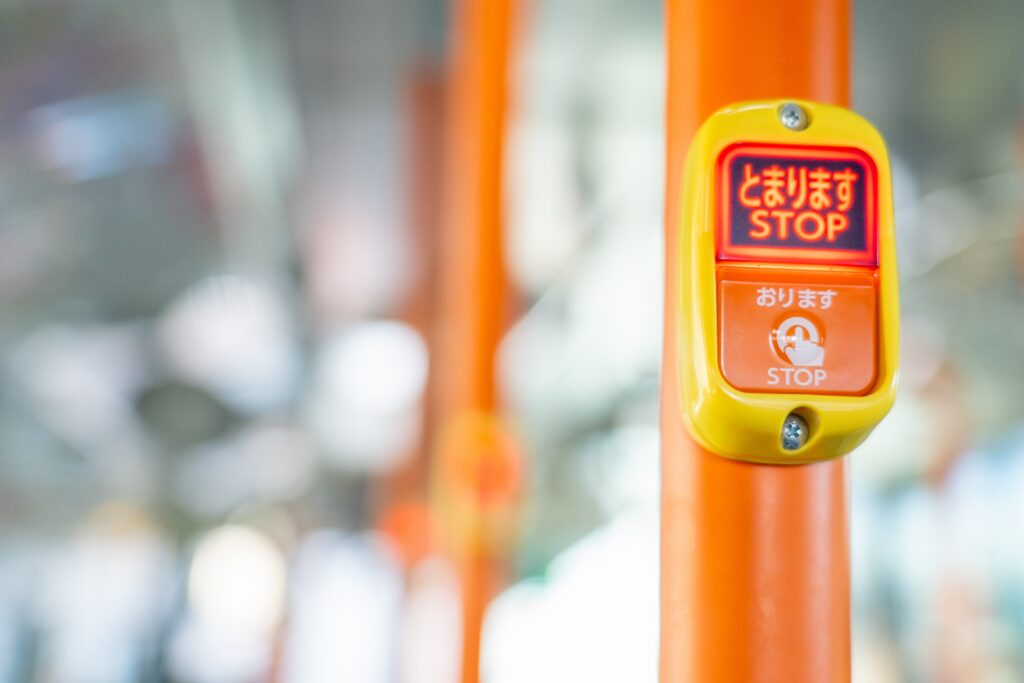 A stop button on a Japanese bus
